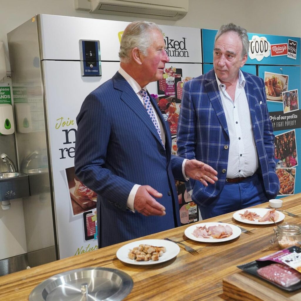 The late founder of Finnebrogue, Denis Lynn with the now King Charles, tasting Naked Bacon at the Downpatrick site.