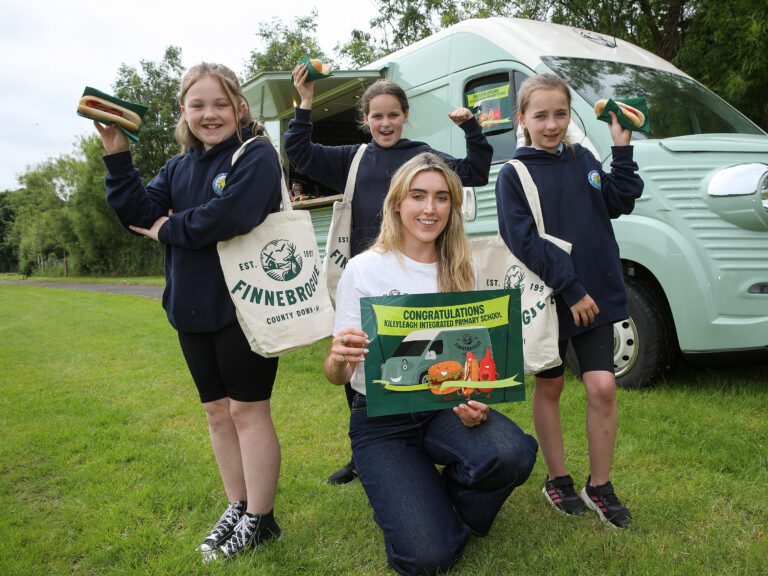 Children cheering at Killyleagh Integrated Primary School with Tara Lynn, Finnebrogue.